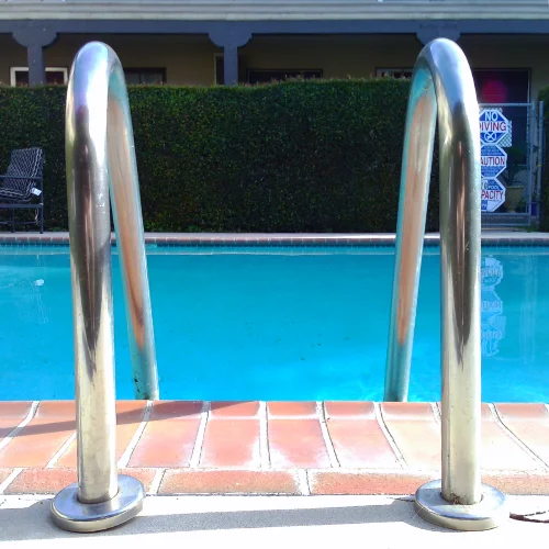 The classic chrome pool ladder at a 
			swimming pool
